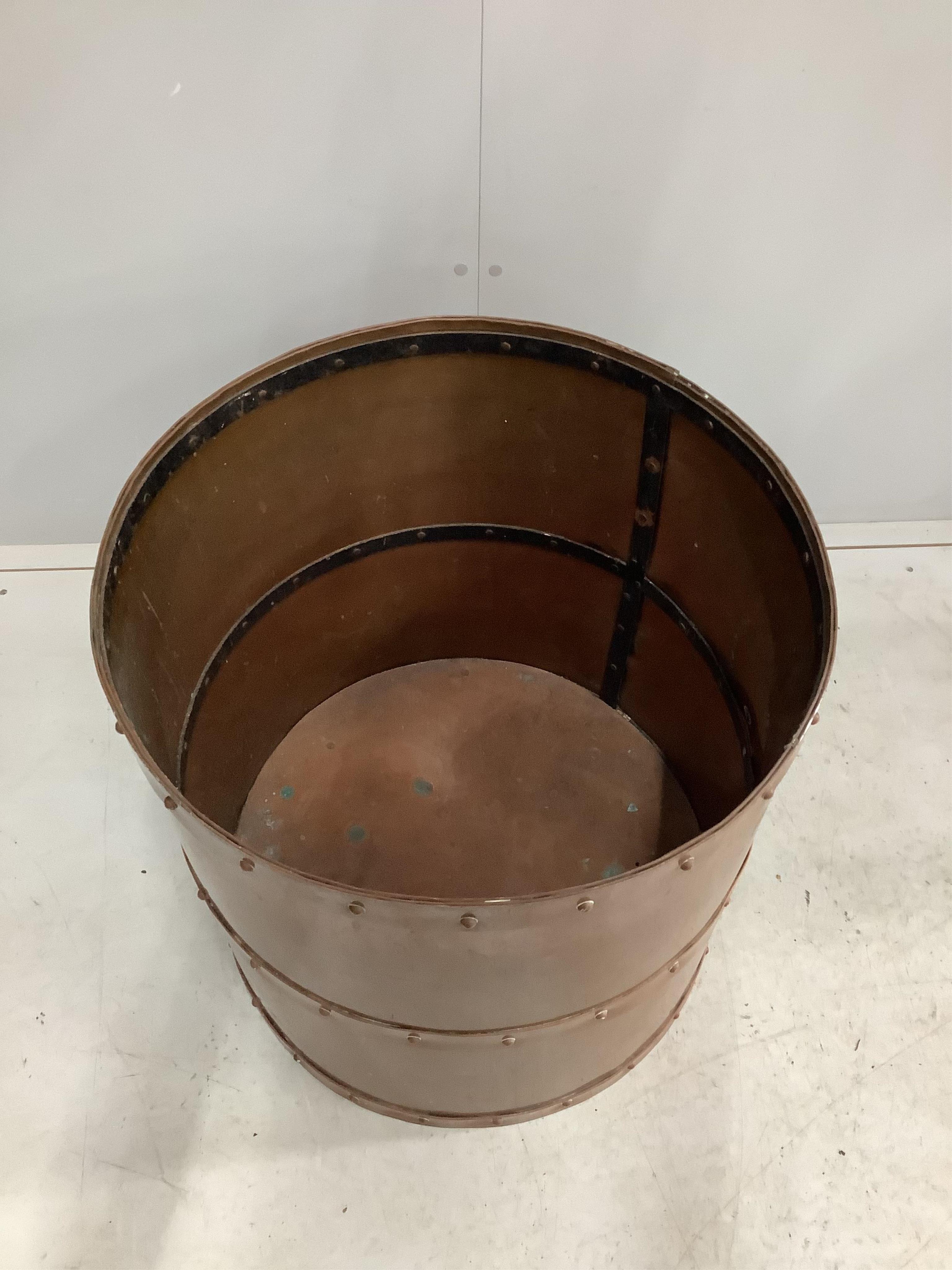 A large copper tub with wrought iron internal banding, diameter 58cm, height 61cm. Condition - good